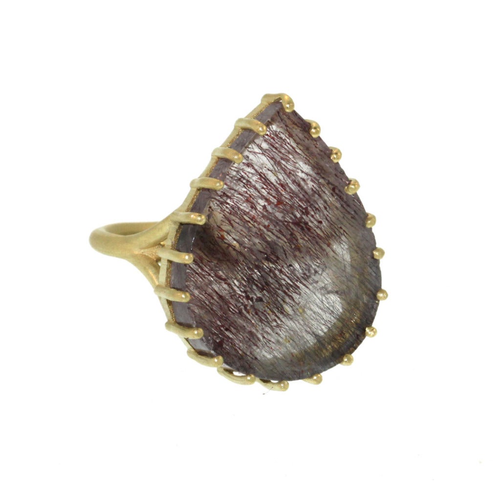This is such a fun and chic take on your classic cocktail ring. The 18k yellow gold prong setting gives this piece a great modern feel, allowing the mesmerizing rutilated quartz to truly shine. The 26x21mm quartz cabochon is 18.37ct and rises 6mm