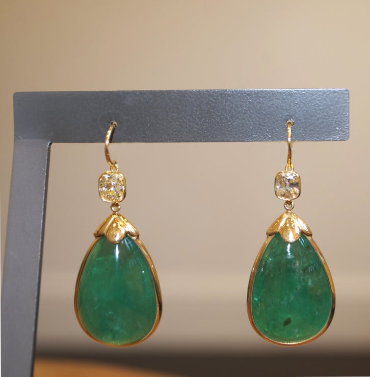 Emerald and Diamond Earrings. These exquisite earrings each have a approx 23 ct pear shape Emerald with an old mine cut and .75 ct Diamonds. Emerald total weight approximately 46 cttw. Inclusion free diamonds total weight approximately 1.5 cttw.