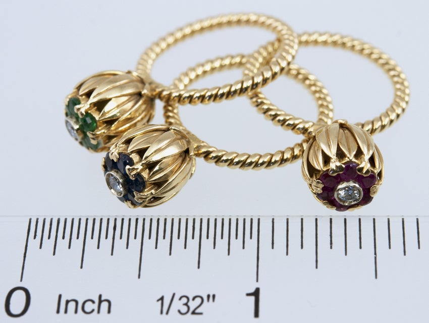 This exact ring is in the NARDI Jewelry book. Nardi manufactures in both Italy and the US.  These are probably from the US and since they are not signed, I'm just attributing them to NARDI.  Anyway...they are 18K yellow gold tulips, one has