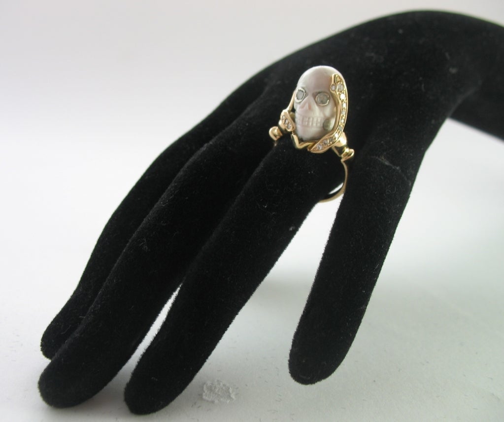 The ivory skull with rose cut diamond eyes mounted on a snake shape setting in 18Kt gold and old-cut diamond.



Size 7
