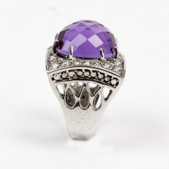 Stunning Dress ring centering a faceted cabochon checkered Amethyst, surrounded by twenty-four round brilliant-cut diamonds; handmade 14K White Gold lattice-worked mounting; Ring size: 7; approx. weight of amethyst: 14.28ct; approx. weight of