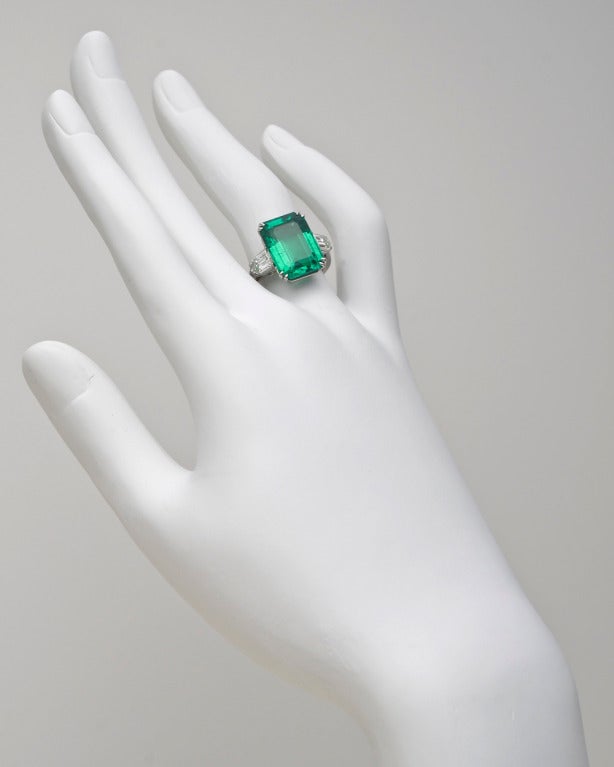 Colombian, emerald-cut emerald ring with fancy-cut diamond shoulders, the emerald weighing 8.20 carats and two diamonds weighing 1.10 total carats, mounted in platinum, numbered 144.034, signed Van Cleef & Arpels. Re-sizable.