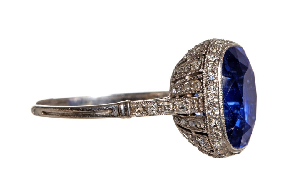 French Belle Epoque natural sapphire and diamond ring bearing French platinum hallmarks and a makers mark on this rare original french ring. The stone surround and ring under gallery feature delicate piercing and early cut, bead set diamonds.  The