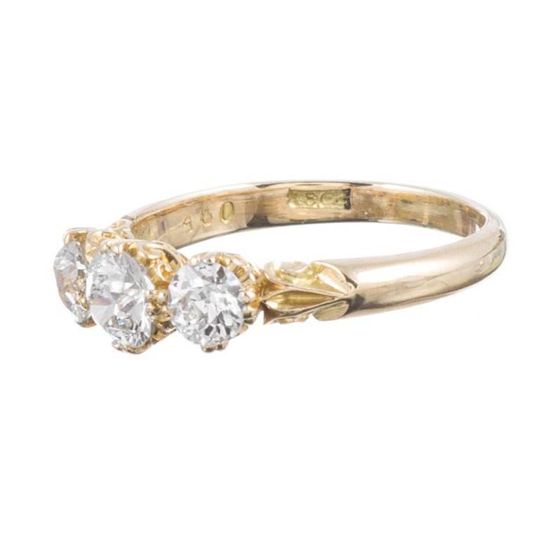 18kt yellow gold three stone diamond ring. Classic Victorian style and a design that offers true timeless appeal, set with a .50 carat diamond in the center and flanked by a .30 carat diamond. Resizable to any size on request.