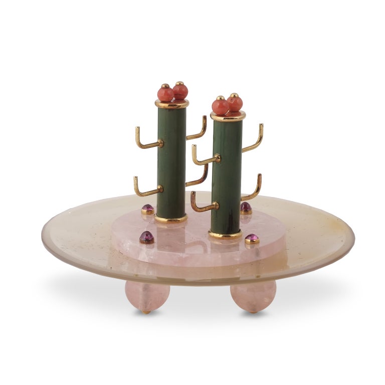 Each of Art Deco design, the rose quartz dish embellished with a green lacquer column with gold cigarette holders, accented with coral and gem-set detail, 1930s maker's mark Verger frères, signed Ostertag.