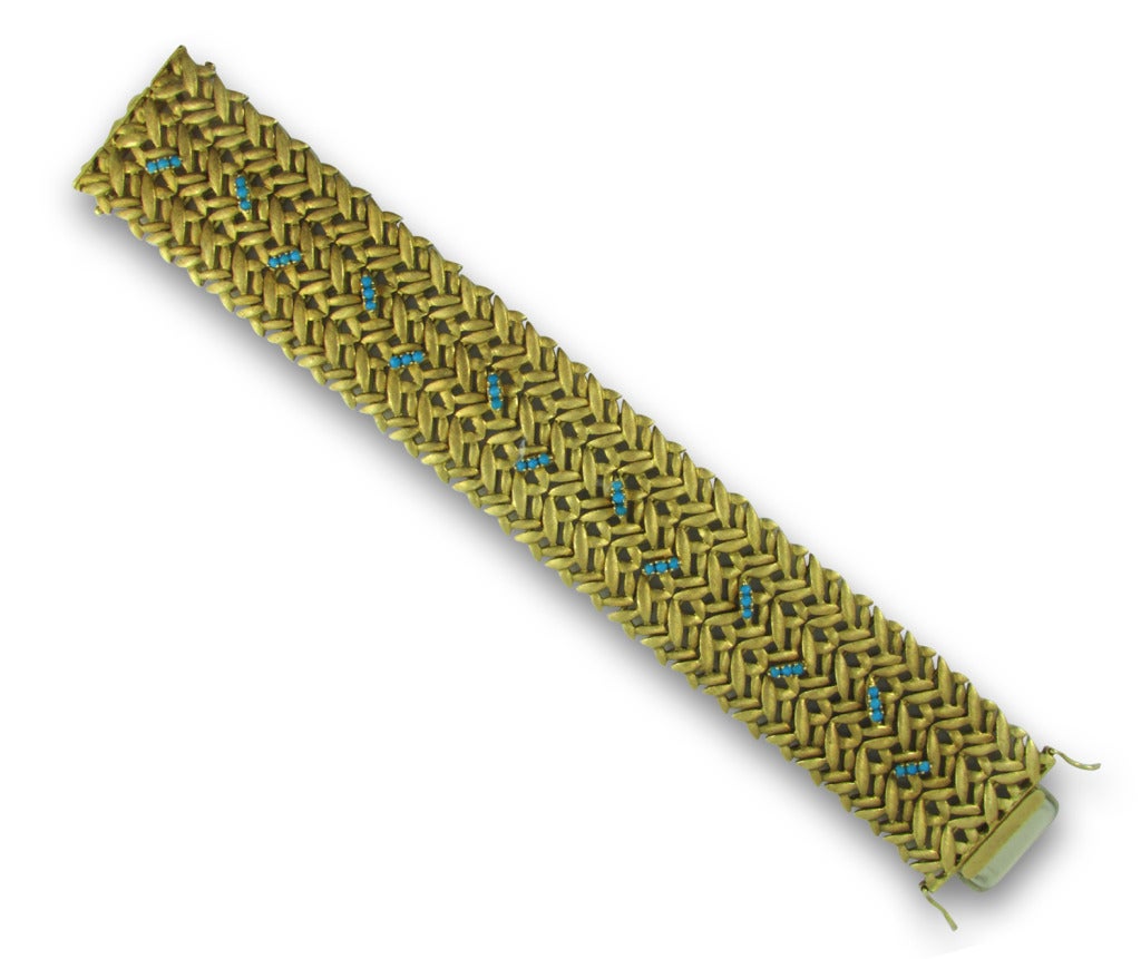 Woven 18KT yellow gold bracelet set with small turquoise beads.