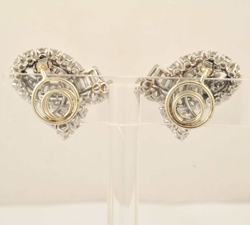 A platinum and 18K white gold pair of Art Deco earring set with Approx. 13 carats diamonds with 38 brillant cut diamonds (approx 5 carats total), 46 emerald cut diamonds (approx. 6,8 carats total) and 2 marquise cut diamonds (approx. 1,20 carats