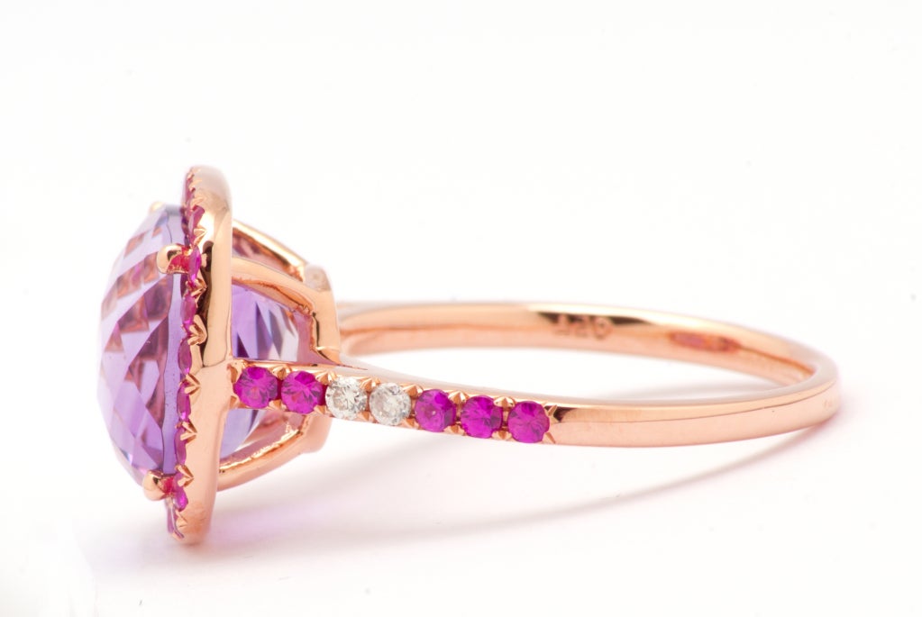 An 18 carat Pink Gold ring set with an impressive 4,50 carats amethyst enhanced with 36 pink sapphire for 0,66 carat total and 2 little round diamonds