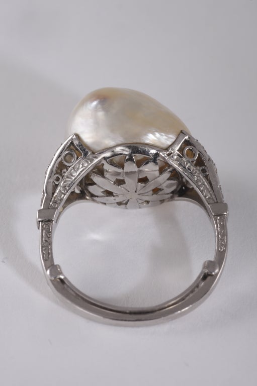 A Rare Natural pearl Art Deco platinum ring, set with diamonds. The baroque pearl is approximately 1,5 centimeter for the diameter.