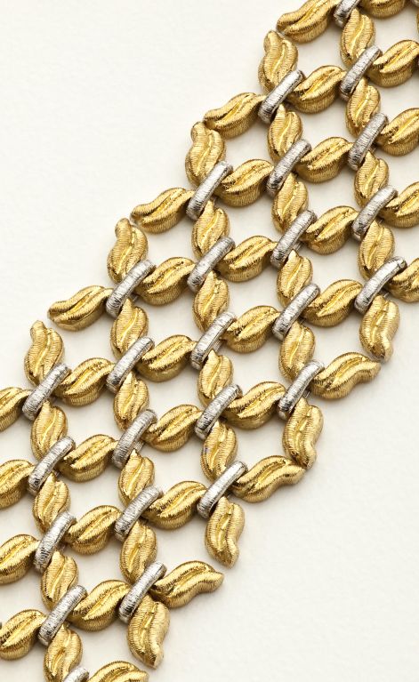 A bi-color white and yellow gold bracelet composed of textured fancy shaped links.  Signed Buccellati 18K Italy.
