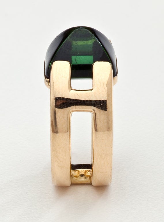 An 18 karat gold ring with a sugar loaf cut green toumaline.  Signed Hermes with inventory mark and French assay mark.  Size 4 1/2 to 5.