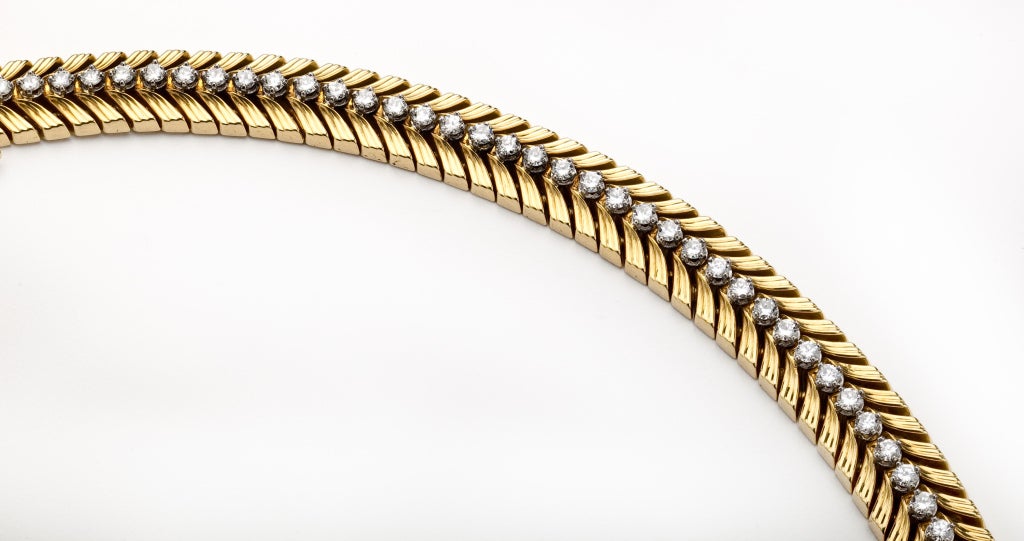 An 18 karat chevron shaped link bracelet centering a row of 48 diamonds.  The diamonds are round brilliant cut with G-H-I color, VS-SI clarity and weigh a total of 2.85 carats.  Signed Cartier, 750, Swiss and an inventory mark of 4252.