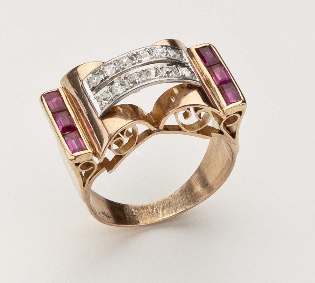 An 18 karat gold Retro ring with twelve full cut diamonds and six baguette cut rubies.  Stamped 750.  Approximate size 7-7 1/2.