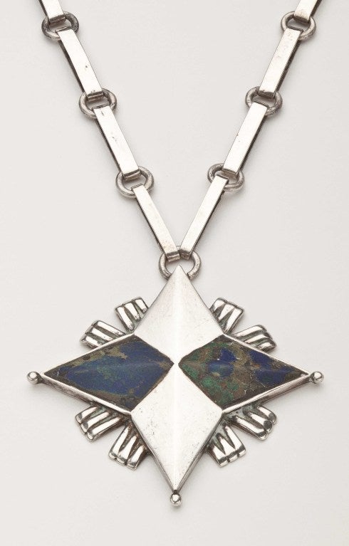 A sterling silver and azurmalachite necklace by American expatriate designer, William Spratling (1900-1967).  This necklace, which shows the influence of Spratling's experiences in Alaska after World War II, has its original sterling link chain.  It