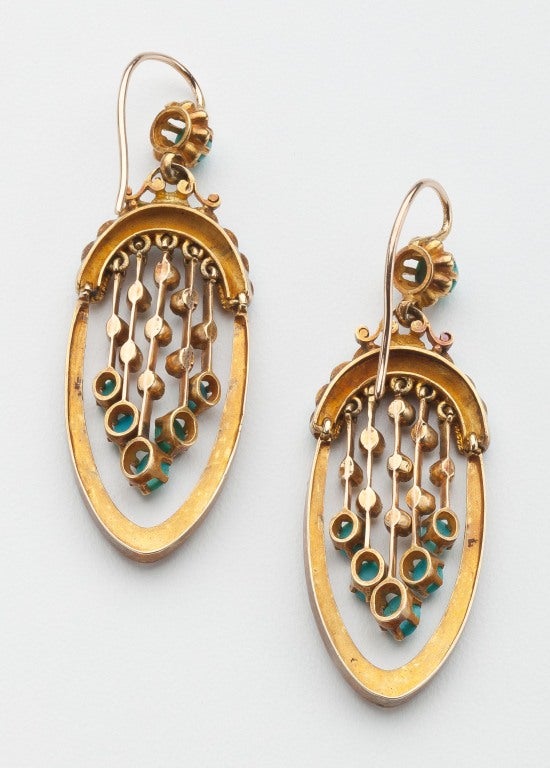 Antique turquoise and pearl earrings set in 18 karat gold from the Napoleon III period.  The oval drops are highlighted by suspended interior drops with turquoise and pearls that gracefully sway as the wearer moves.  Wire backs.  Signed with an