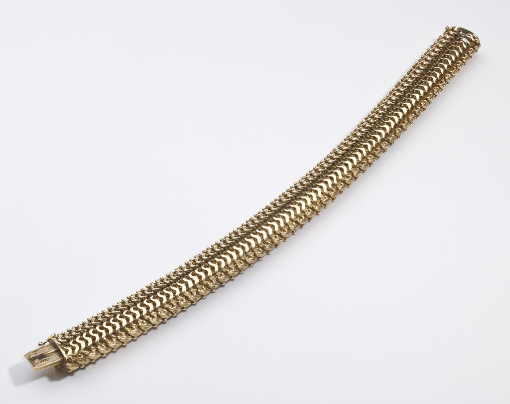 A fancy textured and woven link bracelet by Tiffany in 18 karat gold with bead accents.  The bracelet is also beautifully finished on the back so that it is extremely comfortable and smooth on the wrist.  Signed Tiffany, Italy.  Provenance:  New