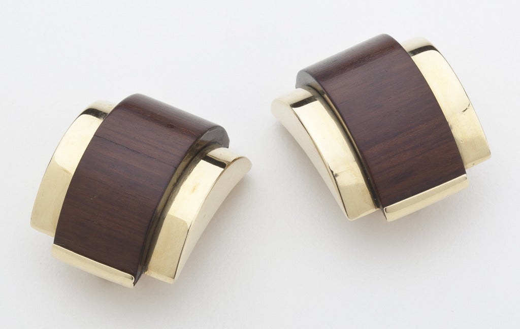 A pair of Modernist earrings that have the bold, exotic look  of what is probably Italian design.  These earrings are made of 18 karat gold with barrel shaped exotic wood highlights.  Impressed 750 mark with additional AL752 mark.

The wood on