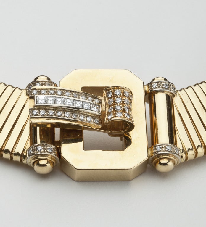 An Italian 18 karat gold and diamond link necklace with a buckle motif.  The necklace is set with 46 round and seven square diamonds, color I-J with VS clarity.  It is stamped Italy 750, and shows Italian assay marks.