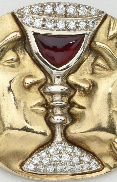 The romantic opera Tristan & Isolde was Salvador Dali's favorite opera.   It inspired him to design this brooch of the two dreamy lovers who are attempting a kiss only to be separated by a golden goblet of garnet and diamonds.  Dali designed the