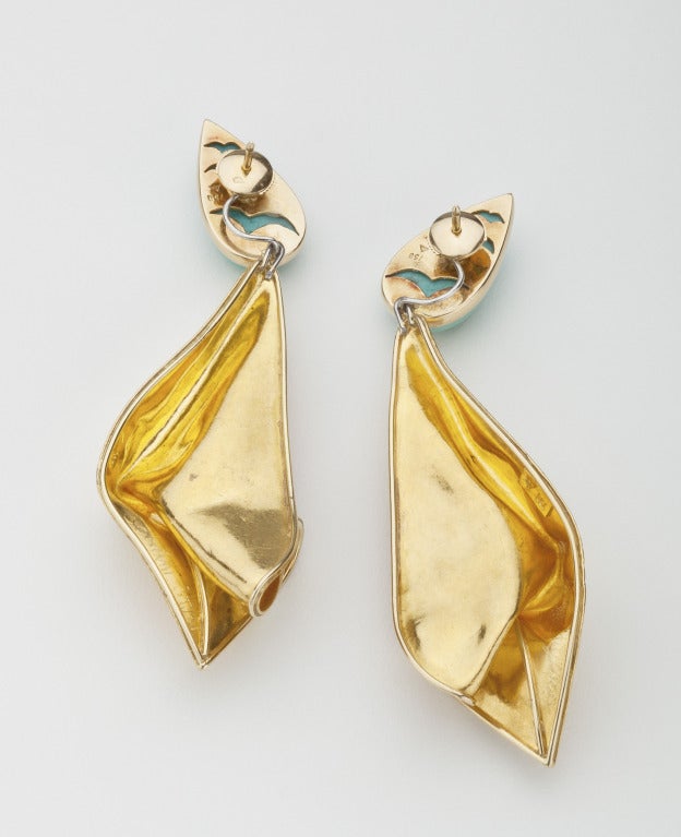A pair of day/night earrings with 18 karat gold drops in an envelope design and topped by pear shaped  Persian blue turquoise.  The gold drop disengages from the turquoise so that the turquoise  can be worn alone  by day and the turquoise with gold