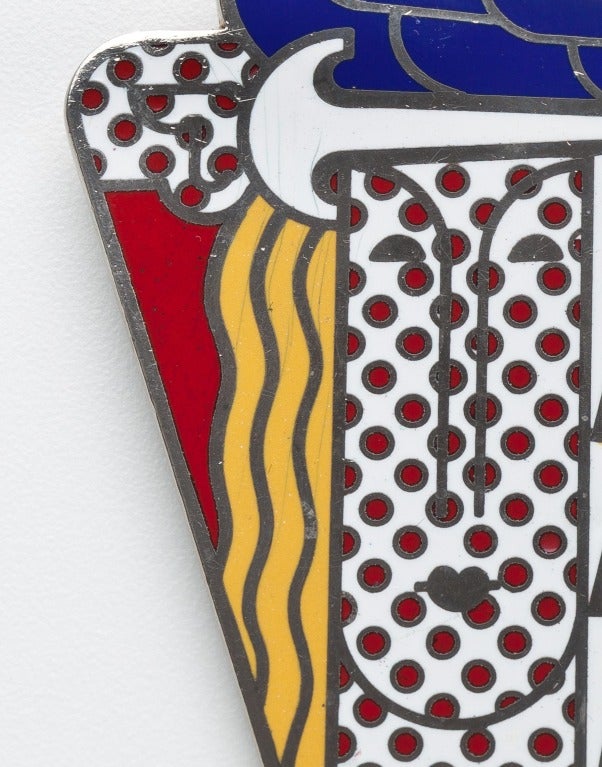In 1968 Pop Artist Roy Lichtenstein (1923-1997) designed this pendant/ brooch in bold polychrome enamel for Multiples Inc.  The piece, which was produced in a limited edition,  was an enormous success and has remained a favorite over the years. 