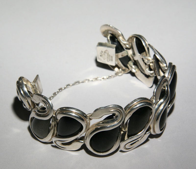 A stylized sterling silver bracelet of swans with obsidian bodies by Taxco's master silversmith, Antonio Pineda (1919-2009).  The bracelet is marked with Antonio's crown hallmark, as well as the 970 silver mark and an impressed mark  