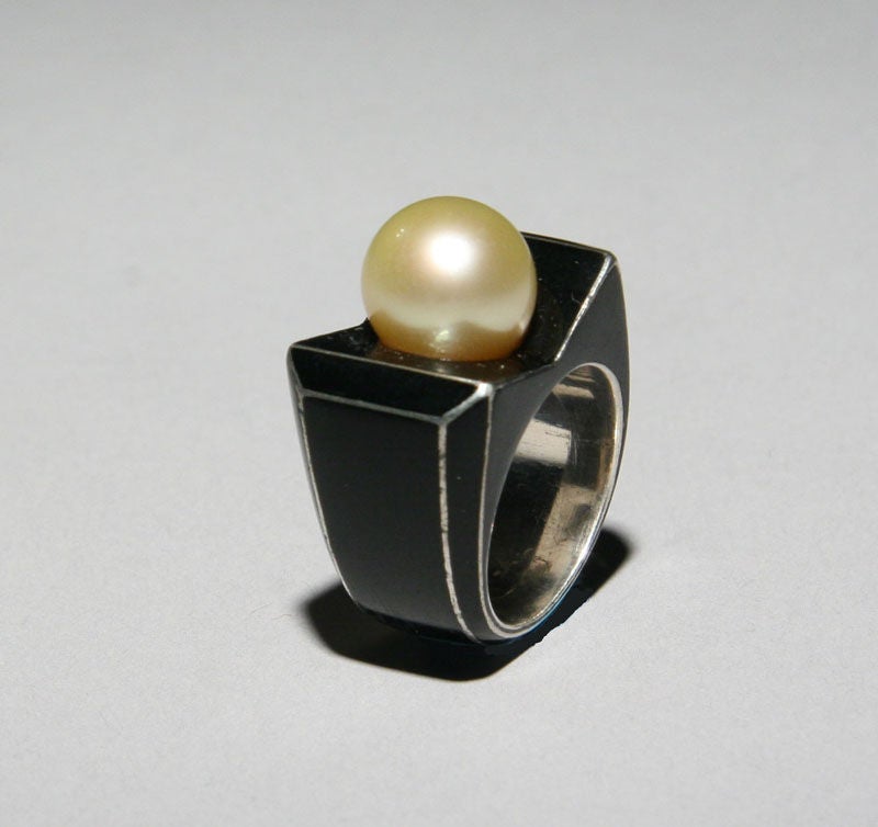 An Art Deco ring by Rene Boivin in sterling silver, black enamel and a round cultured pearl measuring approximately 10.9 mm.  Unsigned .  Accompanied by document from Francoise Cailles, Boivin authority, authenticating the ring. Size 5 1/2.