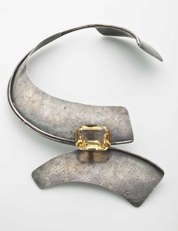 A powerful, abstract sterling silver necklace by American modernist jeweler, Art Smith (1917-1982), with a faceted semi precious stone.  The sterling has the original patinated surface; the stone, which is probably a citrine, has miniscule
