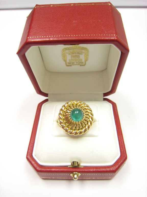 An 18k Yellow Gold Ring Centering an Fine Cabochon Emerald. Signed.
