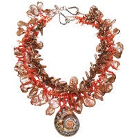 nautilus pendant on a triple strand necklace