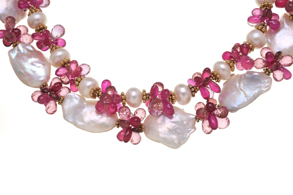 baroque pearl with pink tourmaline set in 18kt gold disc with ruby