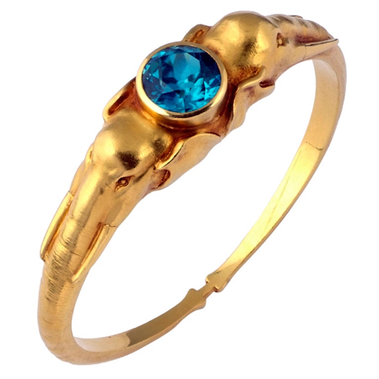 RUCHLLI LUCERNE. A Yellow Gold Blue Zircon Bangle For Sale