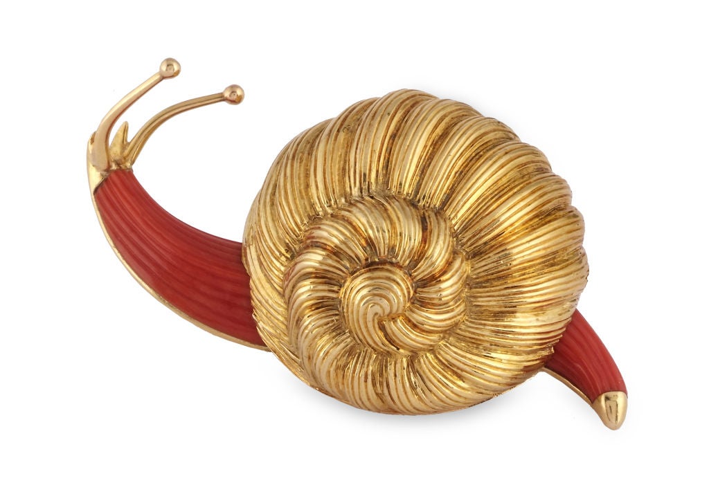 Designed as a stylised snail, with carved coral body and fluted gold shell, 1950s, signed Boucheron Paris, French assay marks for gold.