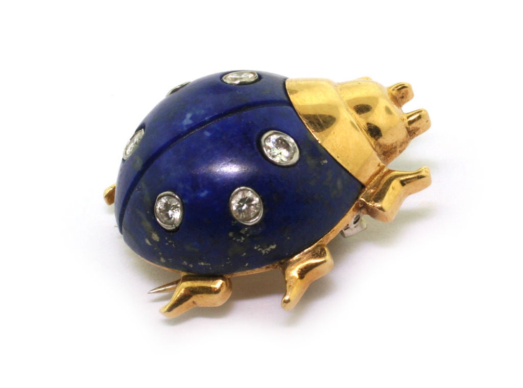 Designed as a stylised ladybird, the shell composed of a fluted piece of lapis lazuli, accented with brilliant-cut diamonds, to a head and feet in yellow gold, circa 1965, Signed Cartier Inc and numbered 5807, French assay and maker's mark for