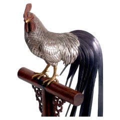 A Shakudo mixed-metal cockerel on a perch.