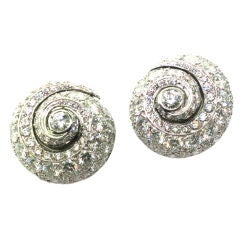 RENE BOIVIN. A pair of platinum and diamond ear clips.