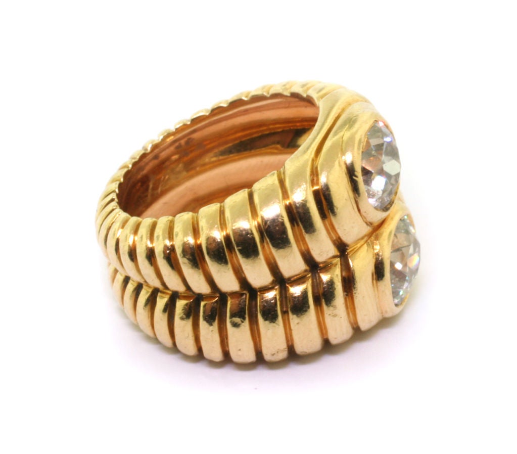 The integral band, designed as two fluted bands set to the front with two collet-set circular-cut diamonds, circa 1940, French assay marks for 18ct gold.<br />
<br />
 Accompanied by a certificate of authenticity by Francoise Cailles.<br />
<br