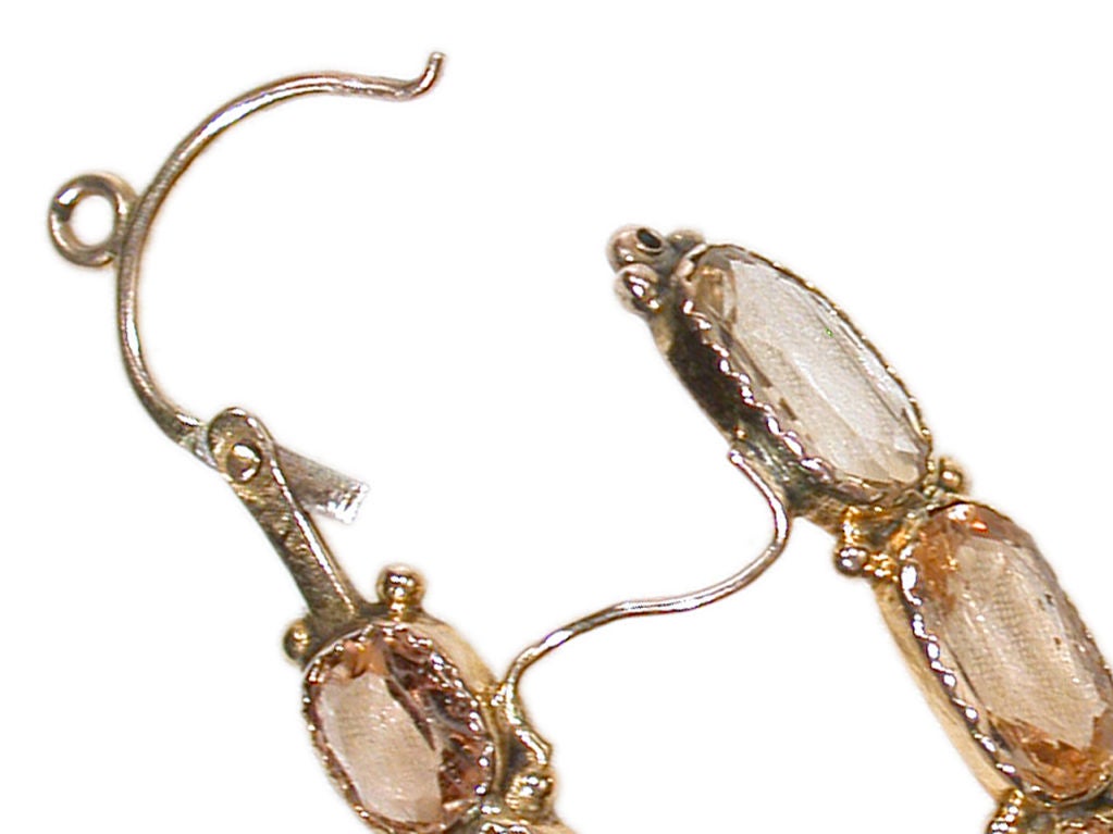 During the Georgian period topaz was perhaps one of the most sought after gems outside of the diamond. Here their marvelous attributes are portrayed in the captivating form of a poissarde earring. Faceted oval stones of topaz decorate the front and