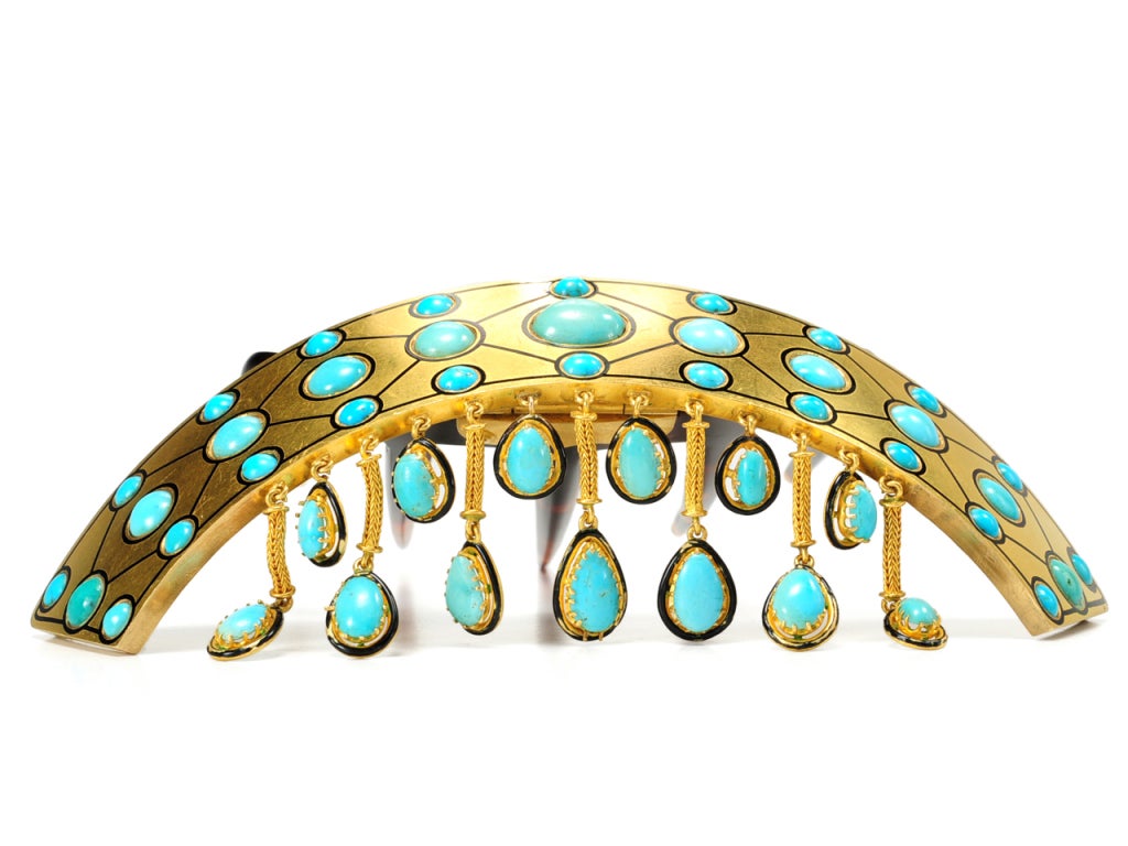 An object as simple as a hair comb can embody an entire artistic style. This magnificent natural tortoise shell hair comb of gold, natural turquoise and black enamel combine in a characteristically large expression to emphasize a singular