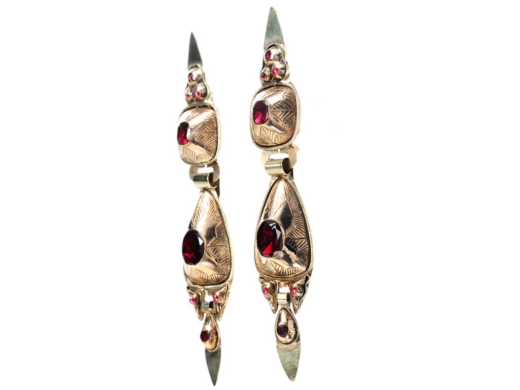 During the late 18th century earrings from the Iberian Peninsula were typically more elongated than wide. Often resembling a stylized variation of the pendeloque form, these earrings display a two to three element design and complete with a pear