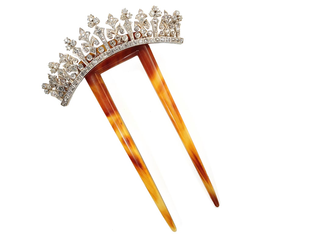 A marvelous double prong comb of natural tortoise shell unfolds its hues of golden honey and warm amber in a demonstration of the beauty of natural material. An arched tiara of silver-topped 14k rose gold is set with one hundred forty-nine (149) old