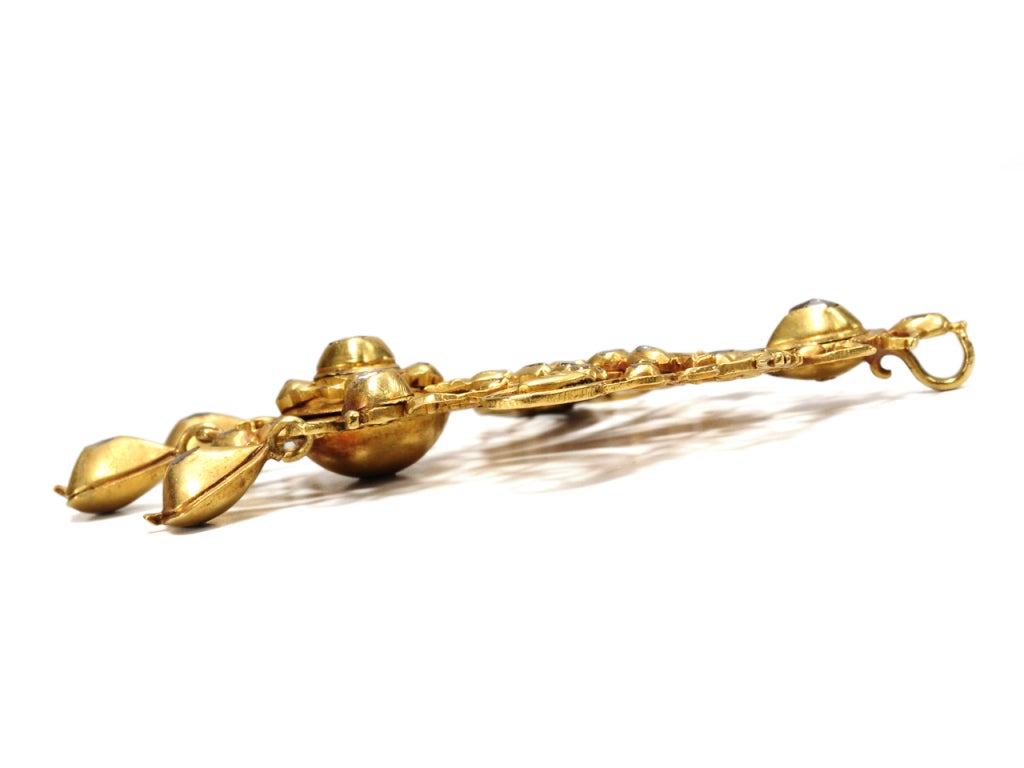 Pieces of jewelry from 18th century Spain and Portugal have a magical appeal. Typically high carat gold, as is this ornate pendant of 18k - 20k yellow gold. Set with forty-six (46) rose cut diamonds, this particular type of mount with its small
