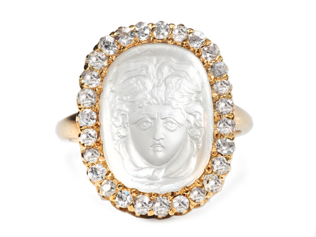 Carved in the tradition of the Renaissance masters is this amazing white moonstone ring. In cameo form, the head of Medusa has been carved from this gemstone which possesses magnificent adularescence. This optical effect, also known as schiller is a