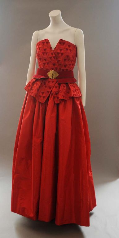 Property of a well known American actress of the 20th c.  Ballgown, domino and matching belt of red silk taffeta, velvet , suede and gilt. The bodice is appliqued velvet and taffeta harlequin pattern and it has a fully built inner corset.The