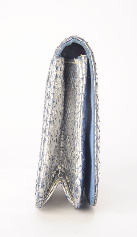 Small, sweet, silvered lizard envelope with blue satin lining.<br />
Shows some soft wear that enhance the authenticity .