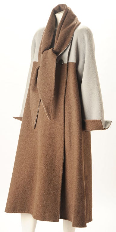 Fabulous double breasted swing coat by the high mistress of beautiful coats with perfect fits.In soft two tone double-faced cashmere and wool with fold up cuffs and self fabric separate scarf or shawl. Two side seam pockets.