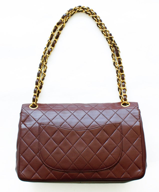 Beautiful muted maroon/burgundy leather 2.55 Chanel bag circa 1970. The bag is in great condition with very little wear. There is some minor wear on the turnlock and logo. 

Measurements:
approximately 10 1/2 inches wide
7 inches tall
2 3/4
