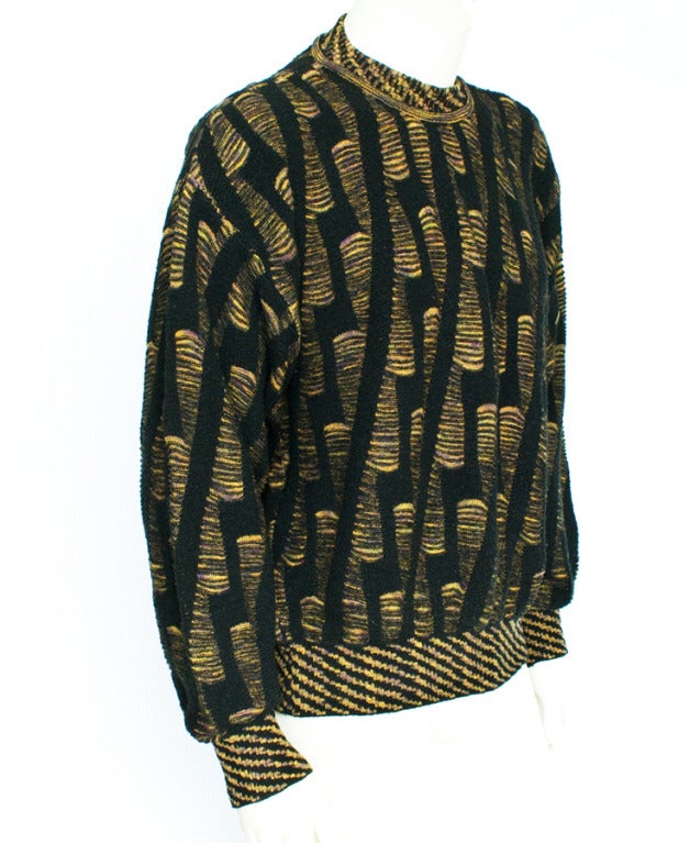 Men's 1980s Jhane Barnes chunky knit sweater made of black and yellow blend fabric (52% cotton, 22% wool, 21% acrylic, 3% nylon, 2% lycra). Knit in a detailed ethnographic pattern.  Barnes is known for incorporating complex patterns into her