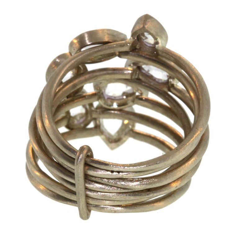 This is a stunning sparkly ring, with pear shape, rose cut diamonds on 7 thin 18k white gold bands connected in the back with a gold bar. Very comfortable and feminine, this could be an engagement ring or an everyday ring. The width of the ring in