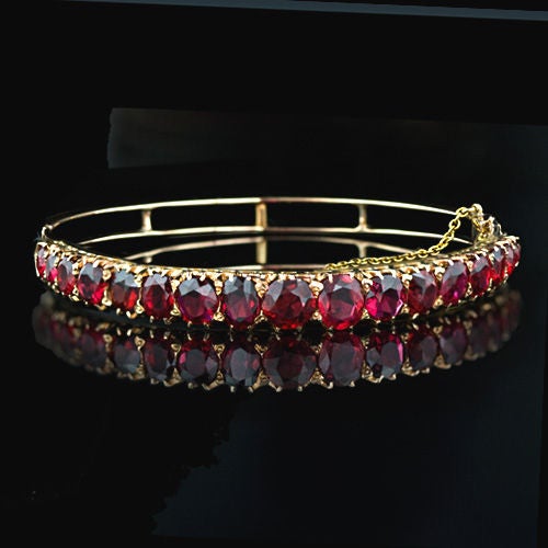 A lovely Victorian bracelet circa 1880-90. This hinged bangle is set with seventeen graduated beautifully matched rich red spinel set in 14 karat rose gold. A very rare collection of gemstones.

Inventory No. 40-3-1276
